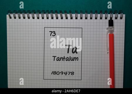 Tantalum - Ta. write on a book isolated on Office Desk Stock Photo