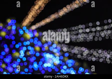 Abstract christmas tree bokeh lights of classic blue and white color blur background. Stock Photo