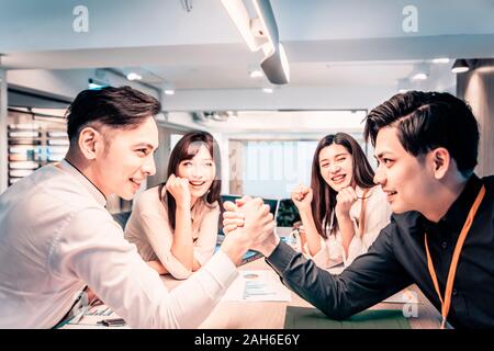 Businessman Competing In Arm Wrestling  at office Stock Photo