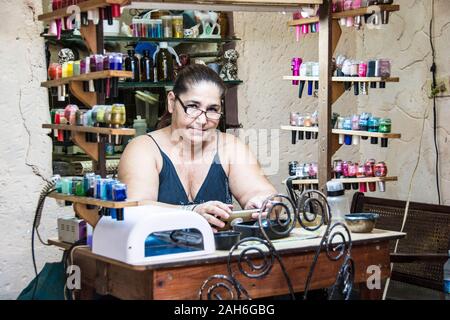 People of Havana Series - A middle aged, Cuban manicurist, at her work station. Stock Photo
