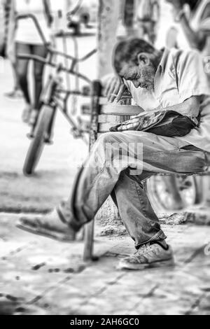 People of Havana Series - A black and white image of an older man, in his late 50s, waiting for the bus early morning. Stock Photo
