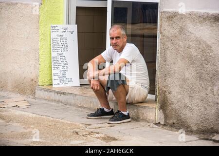 People of Havana Series - A man sitting in front of a restaurant waiting for customers. Stock Photo