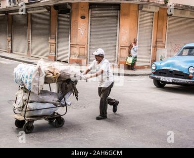 People of Havana Series - A man pushing a cart full of bags of some kind. Stock Photo