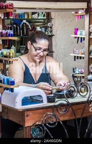 People of Havana Series - A middle-aged, woman, manicurist organizing her station. Stock Photo