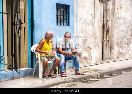 People of Havana Series - Two neighbors talking outside their homes. Stock Photo