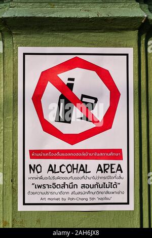 A sign outside a school in Bangkok, Thailand, proclaims the area around the school a 'No Alcohal Area' misspelling the word alcohol Stock Photo