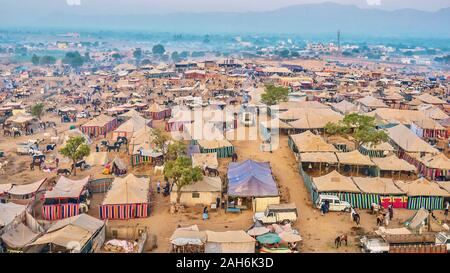 Aerial view of a misty early morning at the annual Pushkar Camel Fair, where festive tents are set up in the horse trading section. Rajasthan, India. Stock Photo