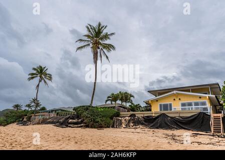 Sunset Beach, Hawaii/USA- Dec. 24, 2019: Loss of yards and homes due to beach erosion on Sunset Beach, Oahu, Hawaii Stock Photo