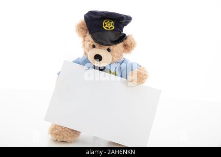 Police and security concept. Cute teddy bear in police officer uniform holding a blank card isolated against white background, copy space Stock Photo