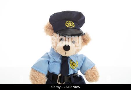 Police and security concept. Cute teddy bear in police officer uniform isolated against white background Stock Photo