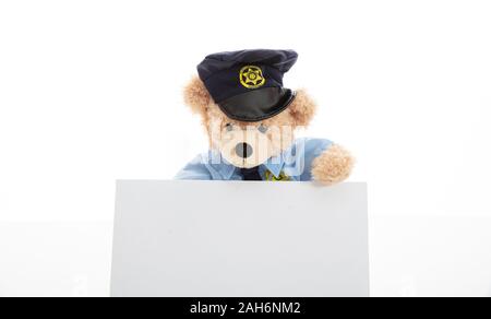 Police and security concept. Cute teddy bear in police officer uniform holding a blank card isolated against white background, copy space Stock Photo