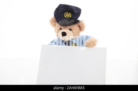 Police and security concept. Cute teddy bear in police officer uniform holding a blank card isolated against white background, copy space Stock Photo