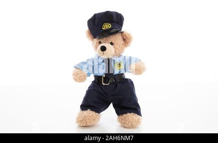 Police and security concept. Cute teddy bear in police officer uniform standing isolated against white background Stock Photo