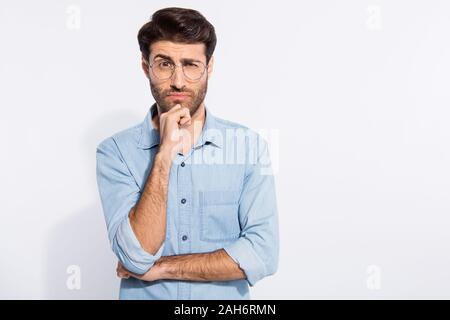I do not trust you. Photo of arabian amazing guy looking suspicious, not believe wear specs casual denim shirt isolated white color background Stock Photo