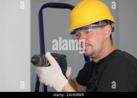 Man in protective helmet and eyewear Stock Photo