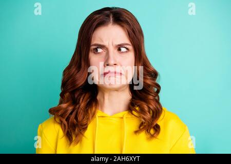 Close up photo of disgusted youngster envious with hating facial expression, furious angry isolated over teal vivid color background Stock Photo