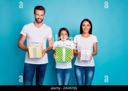 Photo of adopted family taking new year giftboxes overjoyed by amazing, day wear casual outfit isolated blue background Stock Photo