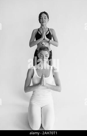 Two Women Doing Yin Yang Pose Practicing Yoga Exercise in Yoga Studio Stock  Image - Image of duet, balance: 199135735