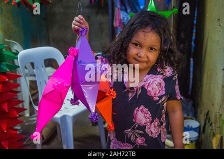 Filipino girl holding a lantern in a Christmas market in Las Pinas city , Manila the Philippines Stock Photo