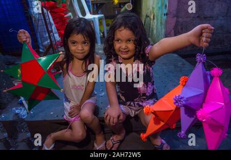 Filipino girls holding a lantern in a Christmas market in Las Pinas city , Manila the Philippines Stock Photo