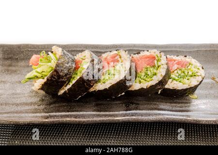5 rolls of Maki sushi wrapped with seaweed on a plate. Stock Photo