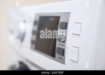 empty screen and buttons on control panel of modern washing machine on blurred background close view Stock Photo