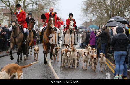 Tenterden, UK. 26th Dec 2019.  Crowds line the high street in Tenterden in the Weald of Kent to watch the horses and hounds of The Ashford Valley Tickham Hunt set off on their annual Boxing Day Hunt.  Credit: Richard Crease/Alamy Live News