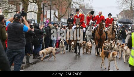Tenterden, UK. 26th Dec 2019.  Crowds line the high street in Tenterden in the Weald of Kent to watch the horses and hounds of The Ashford Valley Tickham Hunt set off on their annual Boxing Day Hunt.  Credit: Richard Crease/Alamy Live News
