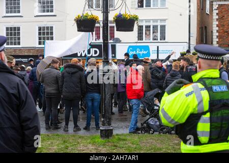 Tenterden, Kent, . 26th Dec, 2019. The annual Boxing Day meet of the Ashford Valley Tickham Hunt is taking place in the centre of Tenterden in Kent. Hounds and horses congregate at ‘The Vine Inn’ pub at 11am before heading down the high street to a packed audience. The weather is wet with drizzly rain. Heavy police presence at the hunt. Police officers with video watch and record the crowd. ©Paul Lawrenson 2019, Photo Credit: Paul Lawrenson/Alamy Live News