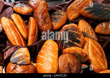 many rolls of different breads in the bakery restaurant Stock Photo