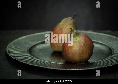 Two pears on a vintage silver platter Stock Photo