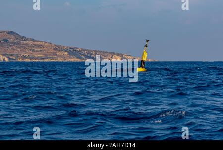Navigational floating buoy - West cardinal mark - in Mediterranean sea Stock Photo