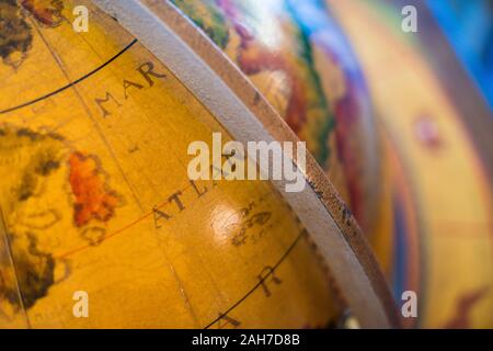 Close up of an ancient orange world globe, showing the atlantic sea Stock Photo