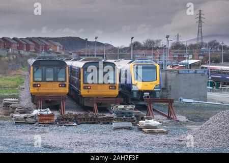 Withdrawn Northern Rail class 142 pacer trains awaiting scrapping with brand new class 195's waiting to enter service at Barrow carriage sidings Stock Photo