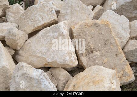 Big pile of large sand stones laying on the ground of construction site. Stock Photo