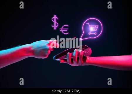 Payment transaction with smartphone. Modern neon color. Concept of online or wireless payments. Stock Photo