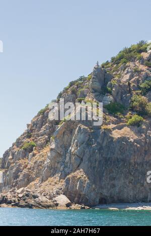 Mountains and rocks on the beach in summer on a Sunny day Stock Photo