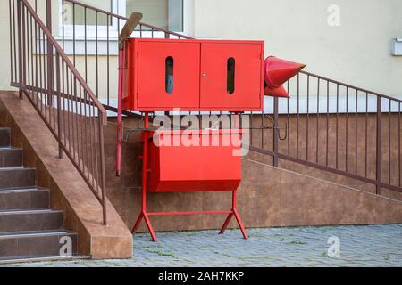 Red fire protection utencils outsine a building. Stock Photo