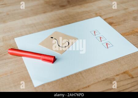 red marker pen near paper with check list and question mark on sticky note Stock Photo