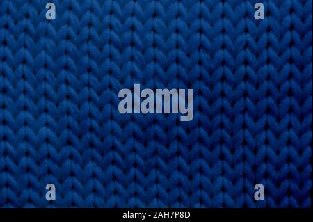 Classic blue tone texture knitted scarf with place for text. Close up trendy 2020 color Stock Photo