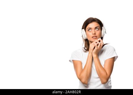 thoughtful young woman listening music with headphones, isolated on white Stock Photo