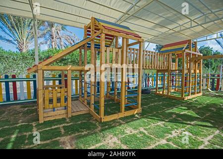 Large wooden climbing frame structure in children's playground area of luxury hotel Stock Photo