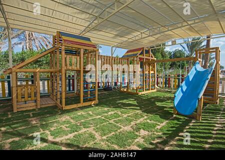 Large wooden climbing frame structure in children's playground area of luxury hotel Stock Photo