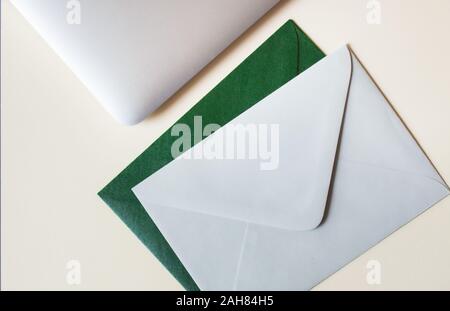 Colorful envelopes and laptop on table. Stock Photo