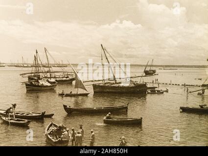 Zanzibar, Dhows and row boats are moored at the Old Harbour in Stone Town, Zanzibar. This harbour was once a centre of trade between East Africa and the Middle East until colonisation of the mainland in the 1880s transferred trade to Mombasa and Dar es Salaam. Original manuscript caption: Dhows anchored off Zanzibar harbour, 1947. 1995/076/1/2/7/6. Stock Photo