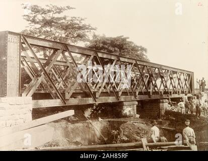 Trinidad & Tobago, Construction workers build a 24-metre railway bridge close to the Caroni River to prevent flooding on a nearby extension line of the Trinidad Government Railway. Caption reads: Caroni flood works, New Opening. 80ft, [c.1895]. 1999/221/1/25/24. Stock Photo