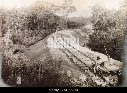 Trinidad & Tobago, Two Trinidad Government Railway workers sit on a hand-operated cart on a newly completed section of the Siparia extension line.Caption erads: No. 128a Siparia Extension Embankment No. 106 15m. 40c. (looking east) 3.4.14, 1914. 1999/221/1/25/57. Stock Photo