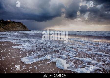 Foam on an empty beach Stock Photo