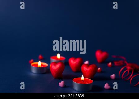 Valentine's day romantic background with hearts and candles. holiday background with hearts. Celebrating weddings and other celebrations with space fo Stock Photo