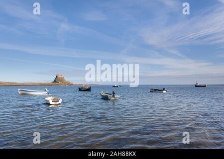Lindisfarne Castle and boats, Holy Island, Northumberland, on a sunny day. Stock Photo